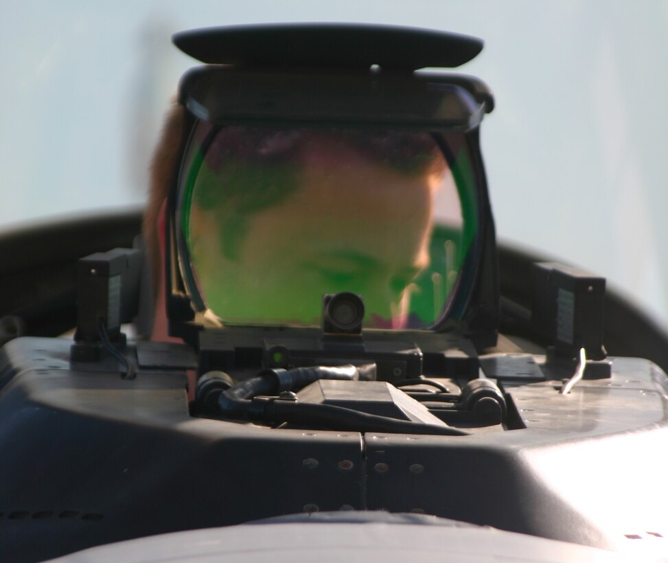 A student pilot from the 80th Flying Training Wing takes and inside look of an F-16 Falcon during Combat Air Force Day Nov. 17. The day is set aside for student pilots from the 80th FTW and maintenance Airmen from the 82nd Training Wing to see upclose some of the aircraft they will work on or fly in the future. (U.S. Air Force photo/John Ingle)