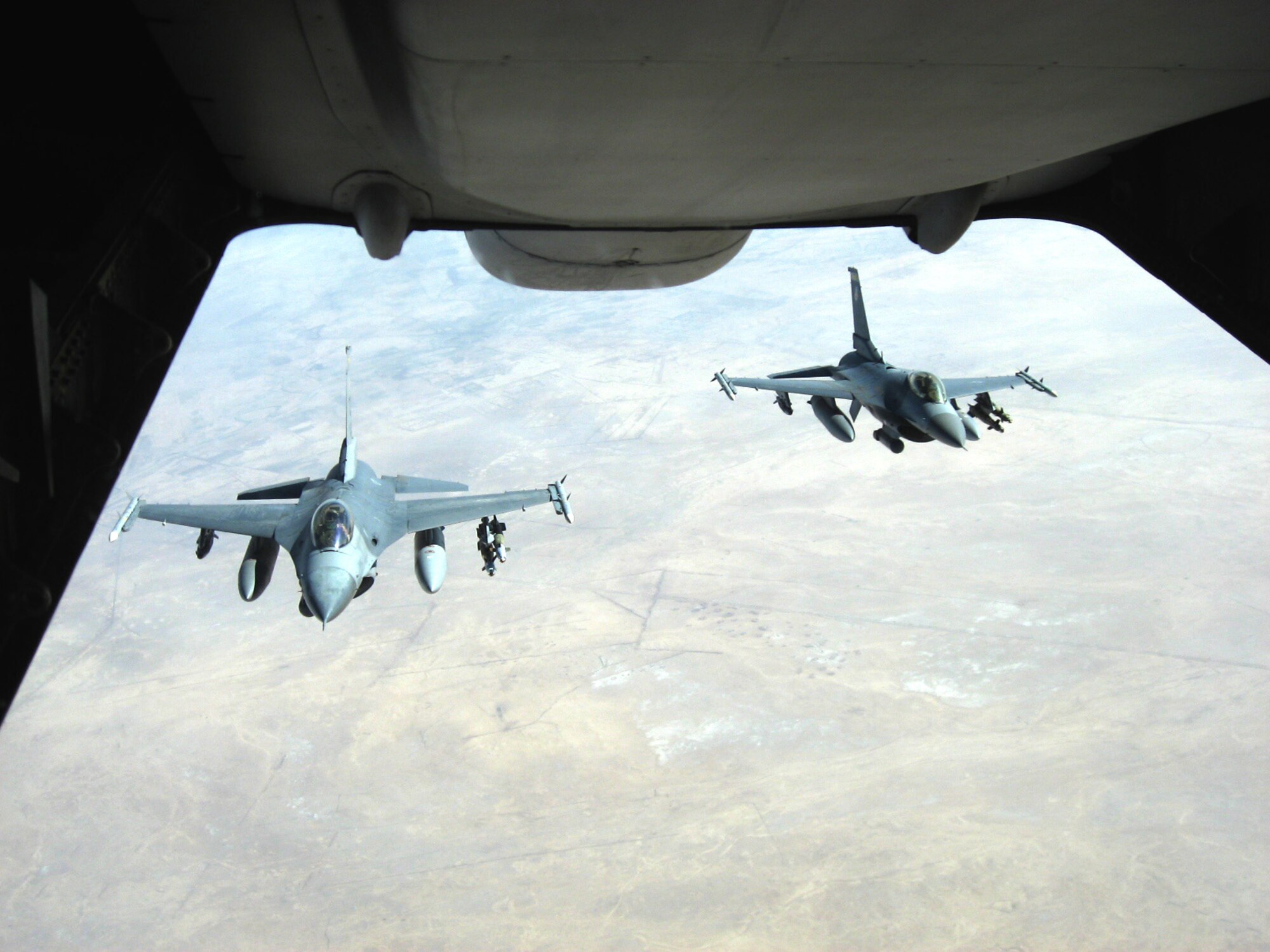 Two F-16 Fighting Falcons from Balad Air Base, Iraq, pull behind a KC-10 Extender to receive fuel before conducting a mission over Iraq Nov. 20. The KC-10 refueled both jets that afternoon in support of Operation Iraqi Freedom. The KC-10 aircrew is deployed in support of the 380th Air Expeditionary Wing. (U.S. Air Force photo/Capt. Justin T. Watson)