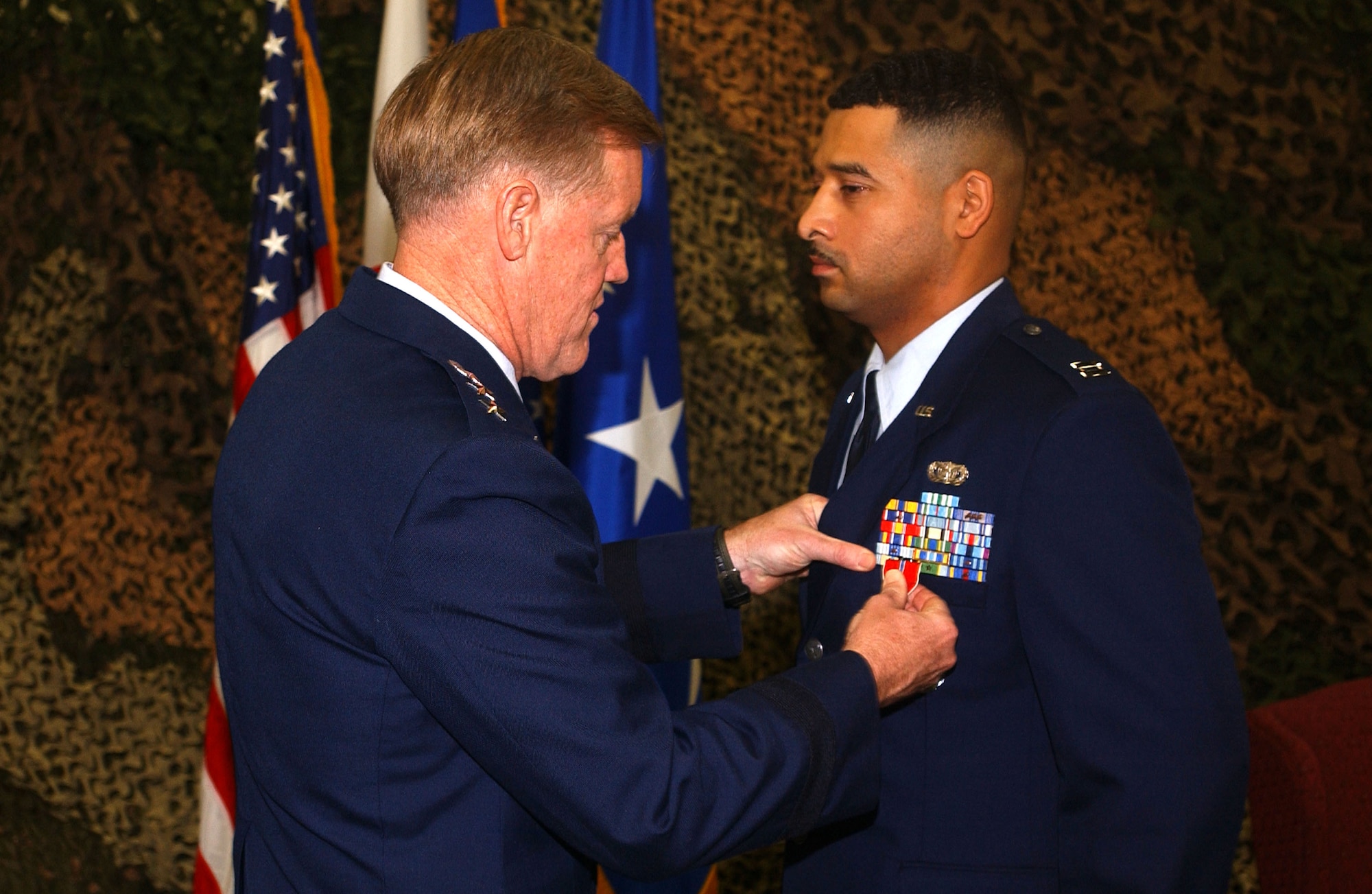 Capt. Russell Waight receives a Bronze Star from 5th Air Force Commander Lt. Gen. Bruce Wright during a Nov. 15 ceremony at Kadena Air Base, Japan. Capt Waight is assigned to the 18th Security Forces Squadron. (U.S. Air Force photo/Airman 1st Class Kelly Timney)