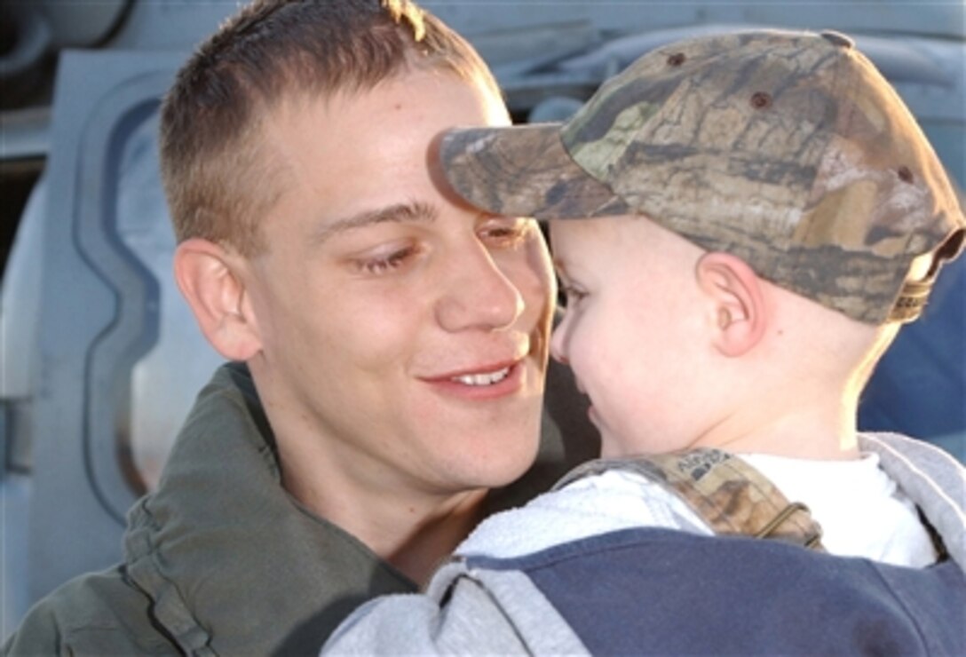 Petty Officer 2nd Class Matthew Castleberry embraces his son during the homecoming of Helicopter Antisubmarine Squadron 11, in Jacksonville, Fla., Nov. 17.  The unit returns from a deployment on the USS Enterprise in support of the global war on terror. 