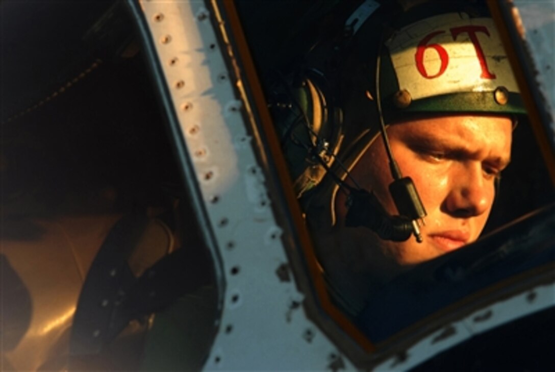 U.S. Navy Petty Officer 3rd Class Leon Threkel runs a daily maintenance check on a E-2C Hawkeye aircraft Nov. 16, 2006, aboard USS Ronald Reagan, which is under way conducting routine carrier operations off the coast of Southern California.