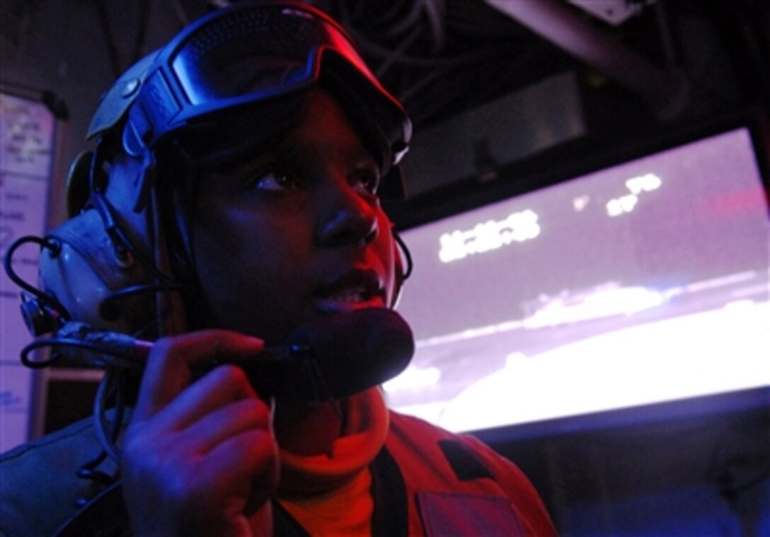 U.S. Navy Airman Kenyata Salas relays a message to hangar deck control aboard the aircraft carrier USS Ronald Reagan (CVN 76) on Nov. 16, 2006.  The Reagan is under way conducting routine carrier operations off the coast of Southern California.  Salas is a Navy Aviation Boatswain's Mate.  