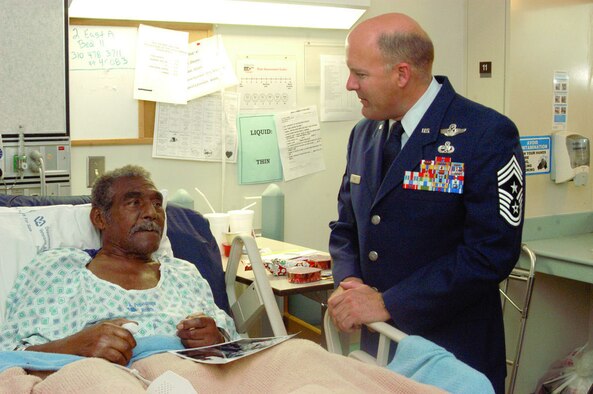 Chief Master Sgt. Steven Hicks, 412th Test Wing command chief, talks with a veteran at the West Los Angeles Veterans Affairs Healthcare Center on Feb. 14, 2006. Eighteen Edwards Airmen visited with more than 60 hospitalized veterans as part of the 2006 National Salute to Hospitalized Veterans week.  (Photo by Senior Airman Jet Fabara)