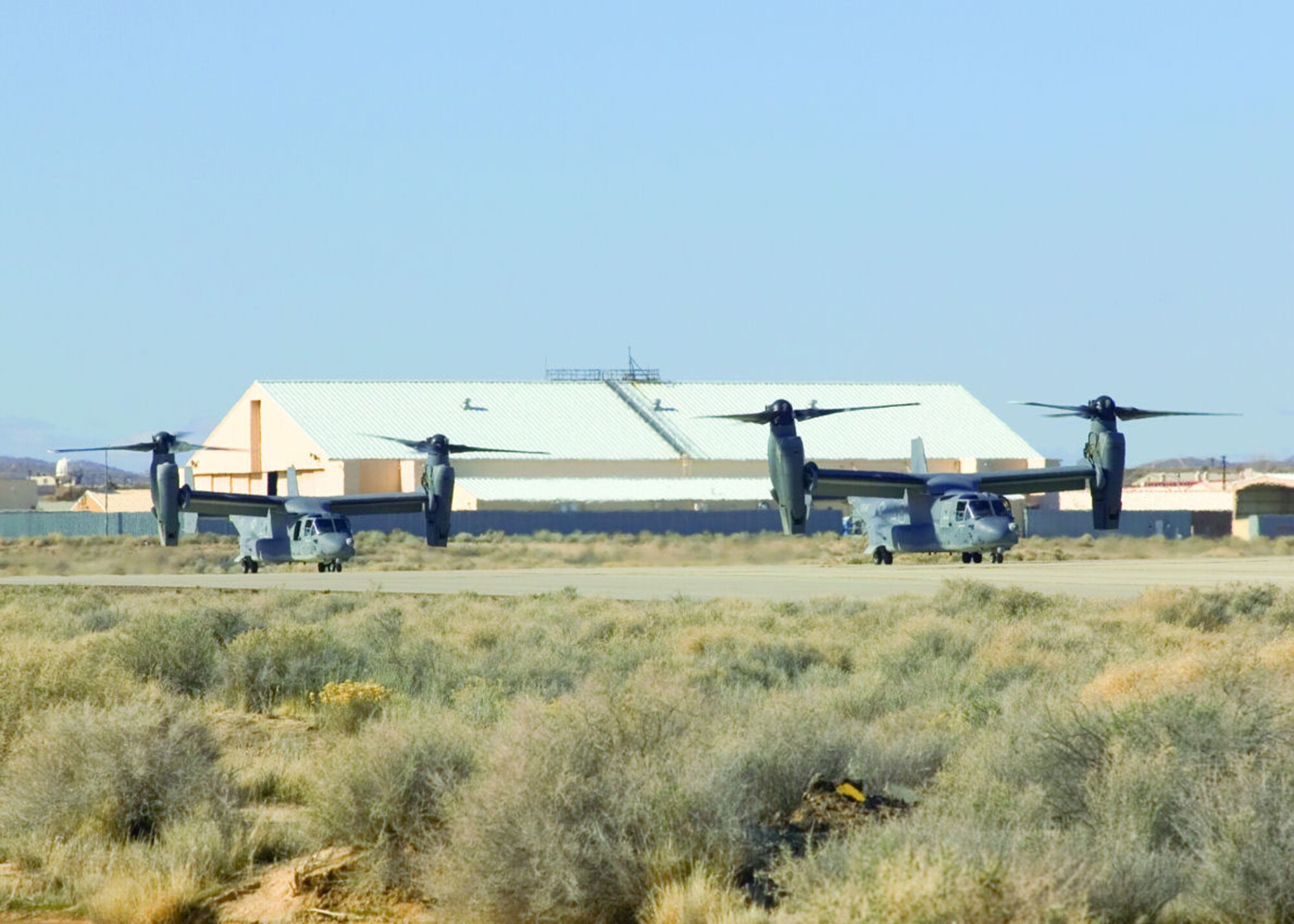 Two Air Force CV-22 Ospreys prepare for takeoff during operational training here. The CV-22 is the Air Force Special Operations variant of the V-22 Osprey tilt-rotor aircraft.   (Photo by Bobbi Zapka)