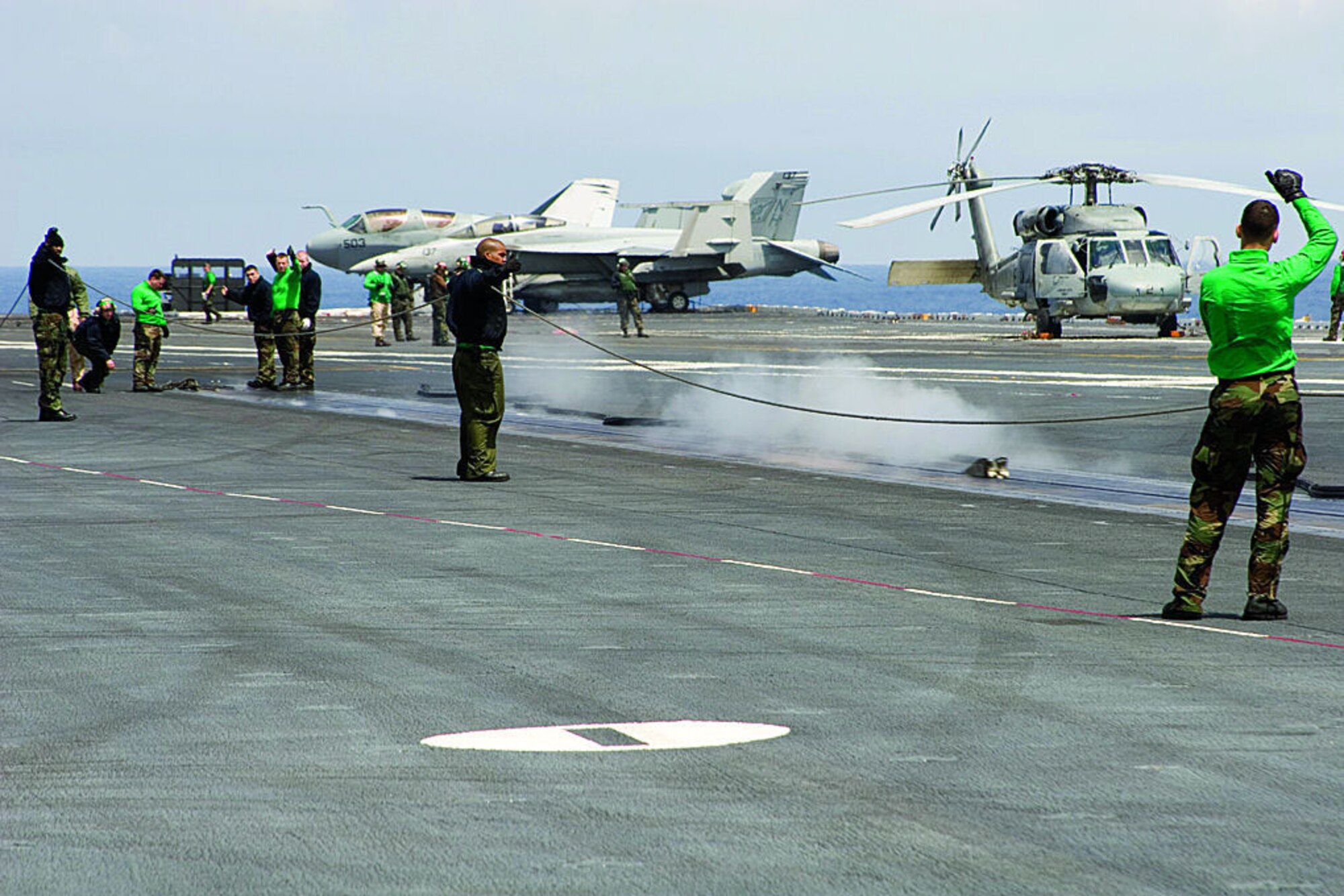 U.S. Air Force Test Pilot School students build relations with Navy personnel during a day trip aboard the USS Stennis out of San Diego. The students watched repeated catches and catapults of aircraft while on the flight deck recently. (Photo by Capt. Troy Welker)