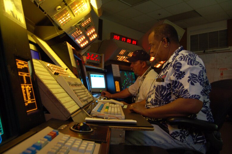 Tim Bryant (foreground) and John Snyder (back), Radar Control Facility's Space Positioning Optical Radar Tracking air traffic controllers, provide an extra set of 'eyes' for the pilots performing test missions. SPORT controllers inform aircrew members of the location, altitude and direction of other aircraft in close proximity as well as air space boundary notifications and weather and airport information. (Photo by Airman 1st Class Julius Delos Reyes)