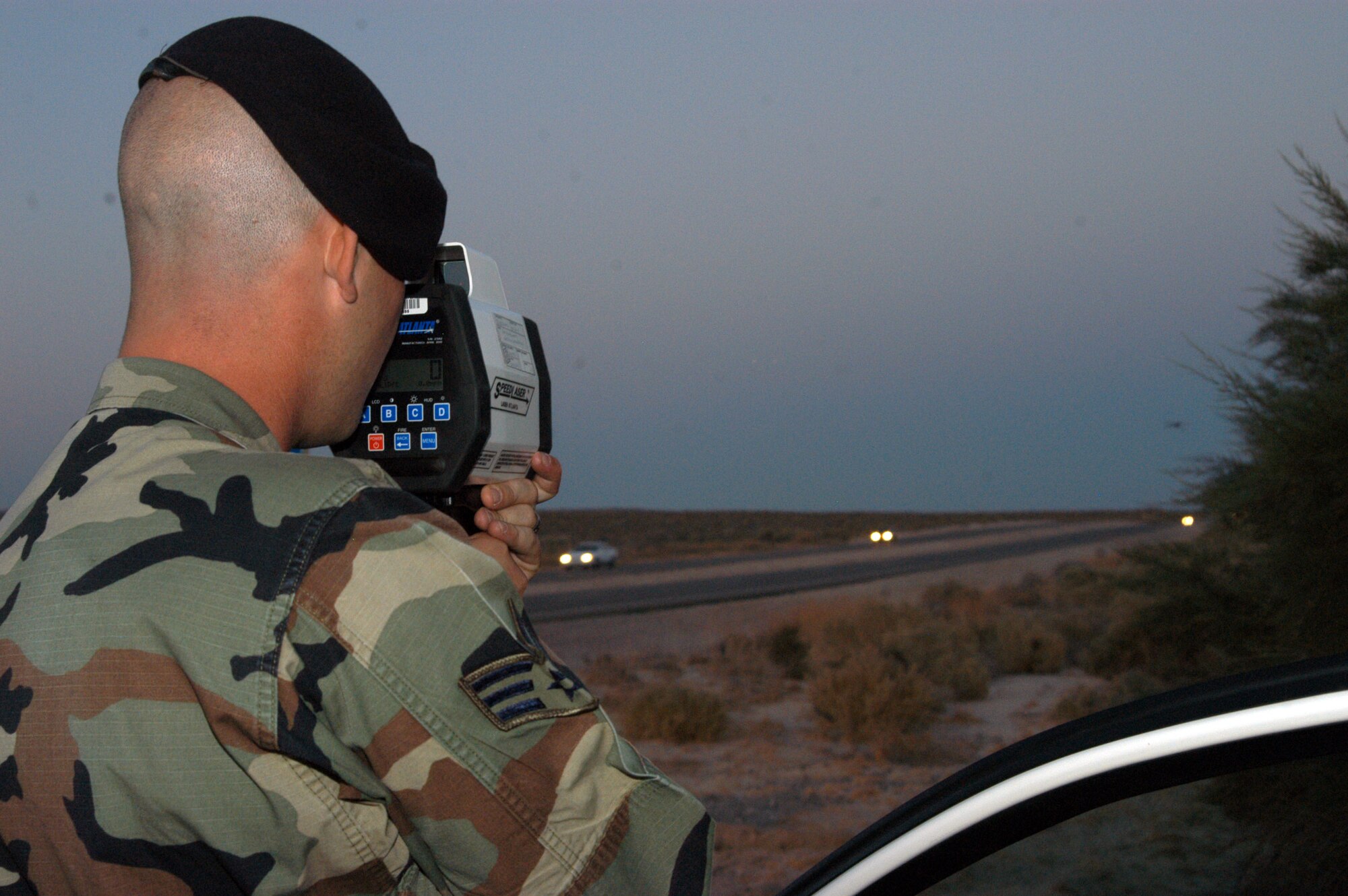 Senior Airman Adam Mastropaolo, 95th Security Forces Squadron installation patrolman, monitors the speed of motorists on Rosamond Boulevard here July 8, 2006. Airman Mastropaolo was using a LIDAR gun that measures the vehicle's speed up to a mile away. One of the mission of 95th SFS is to provide base safety during night time.  (Photo by Airman Stacy Garcia)