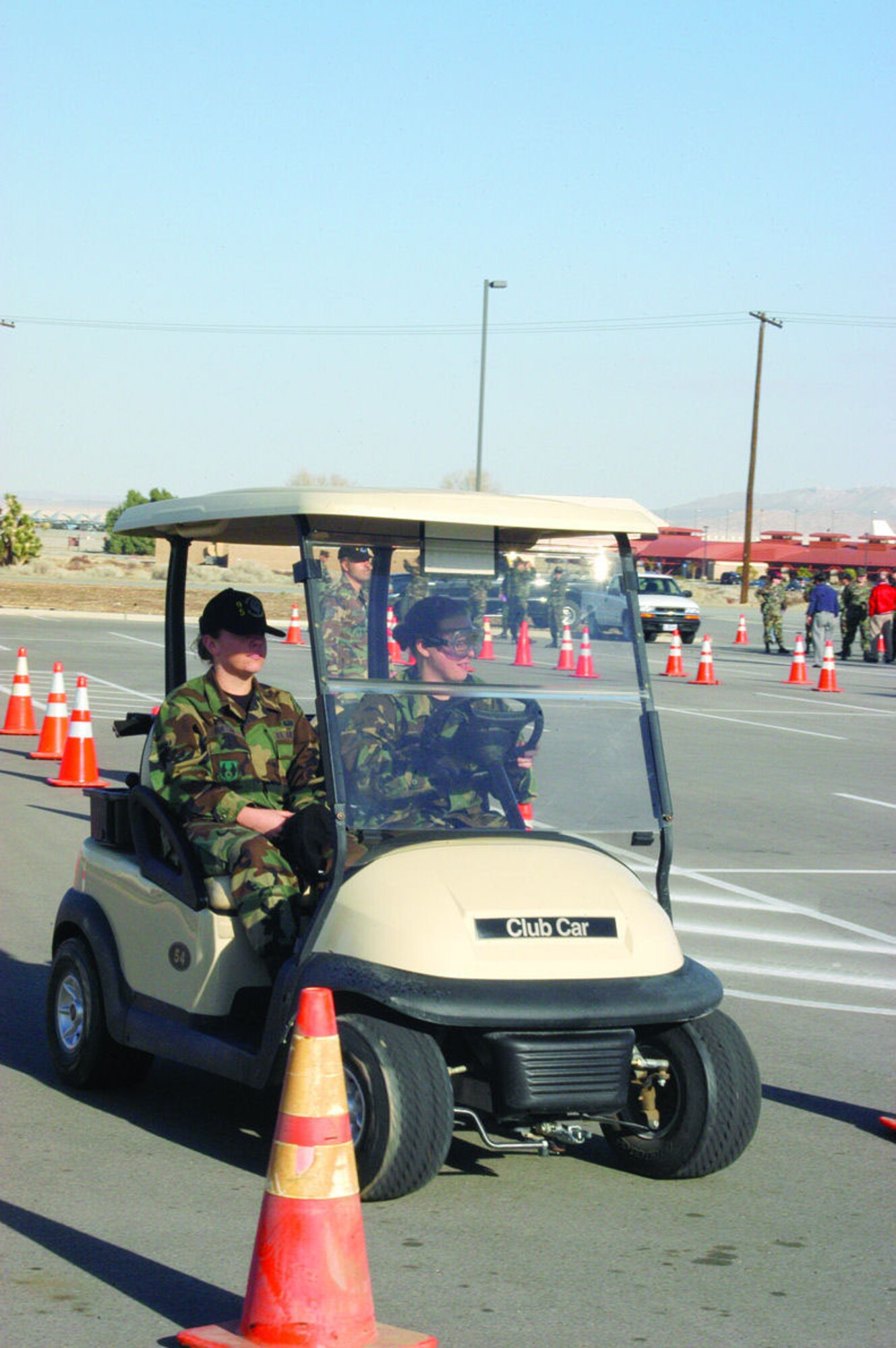 Participants of the 95th Air Base Wing's safety program simulated driving under the influence of alcohol and drugs January 26, 2006, by wearing DUI goggles and operating a golf cart. The half-day program included a safety briefing given by Col. H. Brent Baker Sr., 95th ABW vice commander, along with safety calls held by squadron commanders and DUI demonstrations throughout the afternoon. (Photo by Airman 1st Class Julius Delos Reyes)