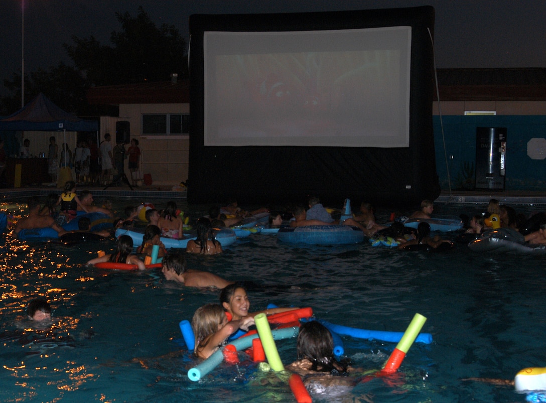 Edwards residents enjoy pool games and two films at the Services-sponsored "Hot Summer Nights" free movie event held at the Sonic Splash Pool on July 15, 2006. Pool-goers watched "Finding Nemo" followed by "Jaws" while casually floating on rafts or lounging poolside.  (Photo by Airman Stacy Garcia)