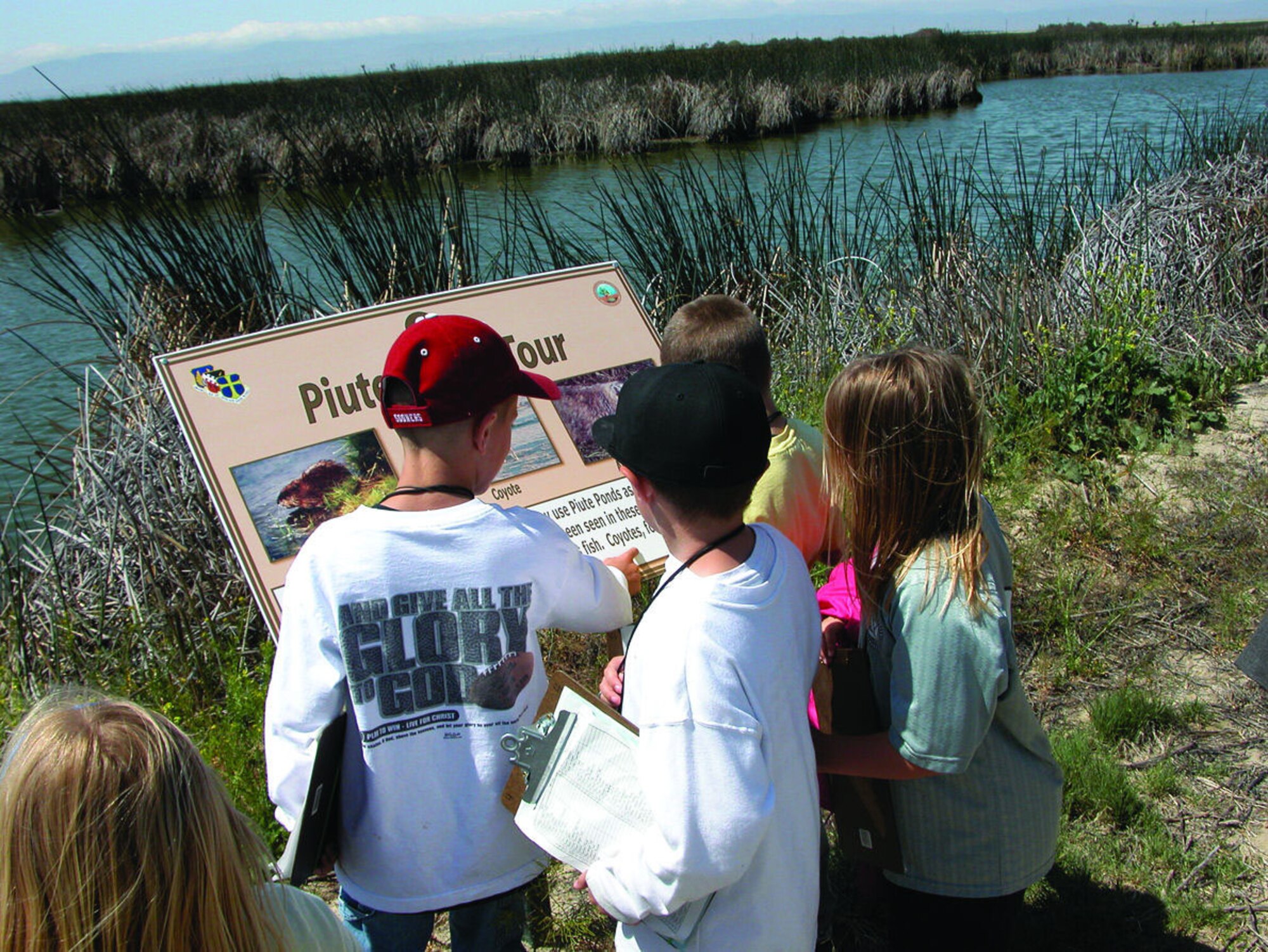 Students from Bailey Elementary School read one of the informational signs located at Piute Ponds. (Photo by Miriam Horning)