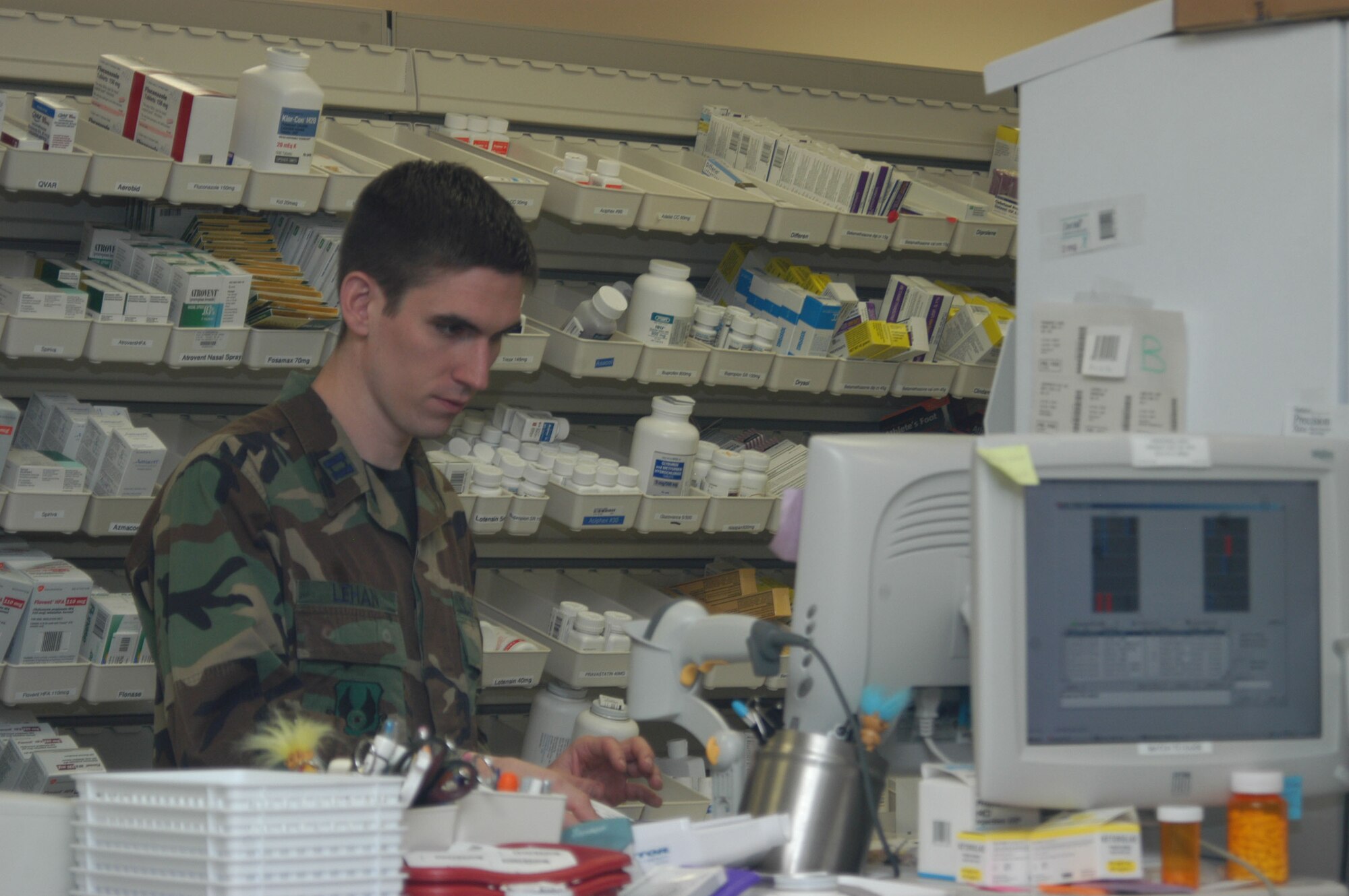 Capt. Jonathan Lehan, 95th Medical Group chief of pharmacy element, checks a prescription in the computer at the clinic here. (Photo by Airman Stacy Garcia)