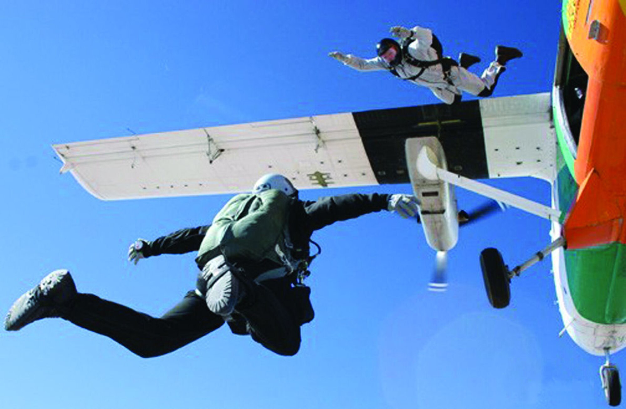 Tech. Sgt. Shawn Studer exits the plane joining Staff Sgt. Scott Lawrence in freefall. The 418th Flight Test Squadron's Test Parachutist program performs more than 150 jumps per year.  (Photo by Staff Sgt. Howard Smith)