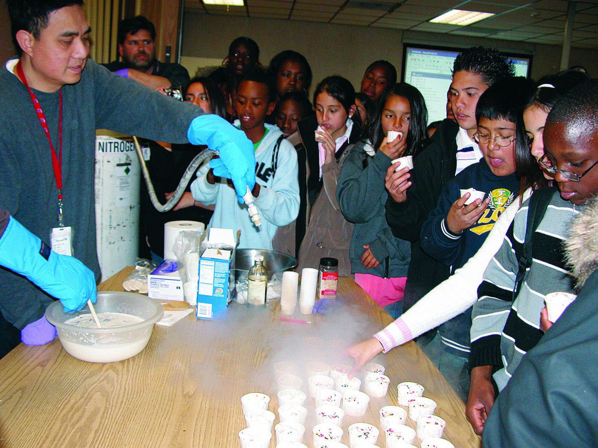 More than 150 students from Columbia Middle School in Adelanto, Calif., receive a "taste" of how their current math and science classes can enhance their future career options during their recent Edwards visit. Students had the chance to see science put into action when staff members made ice cream using nitrogen.  (Courtesy photo)