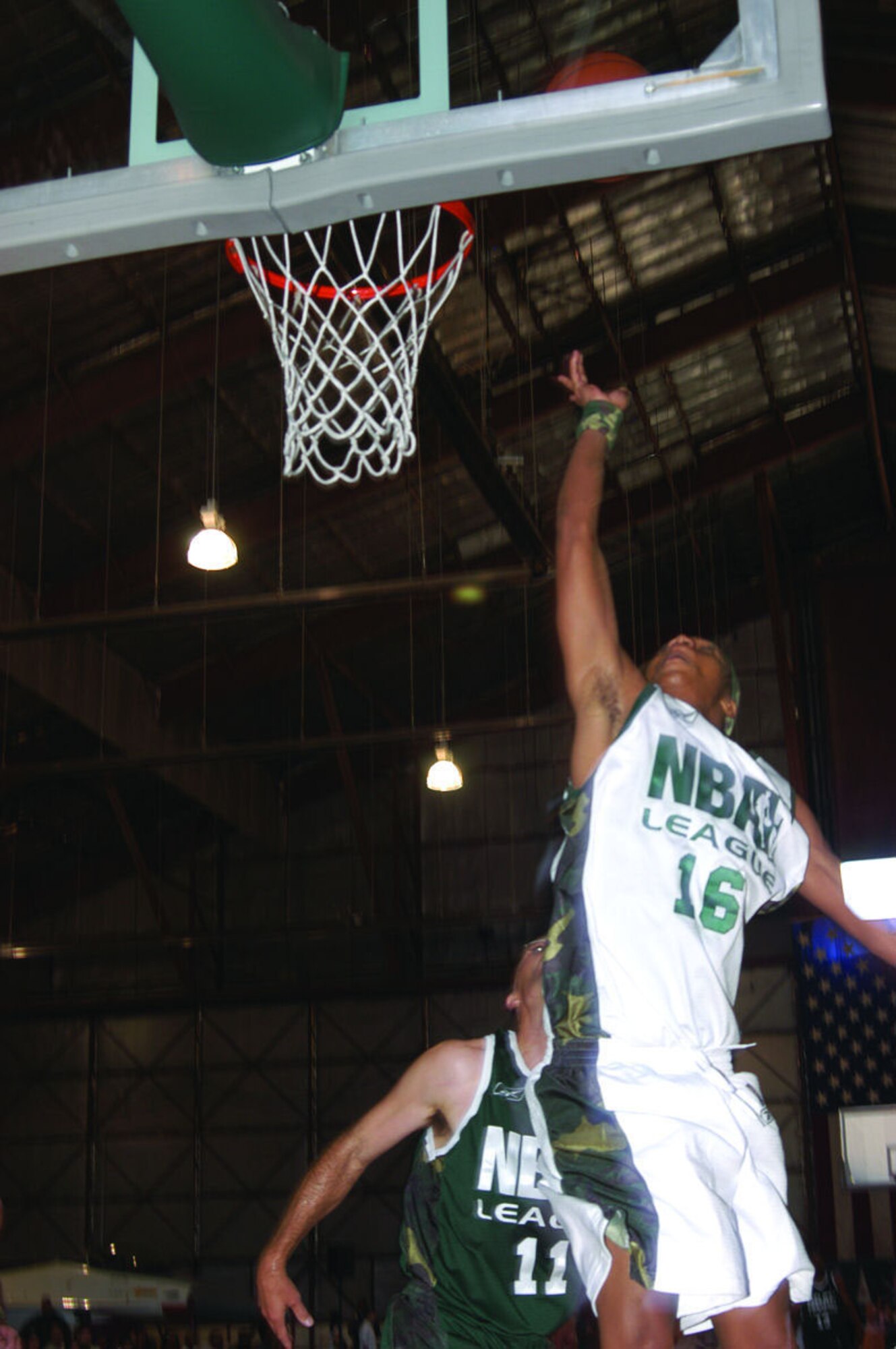 Actor Corey Hardrict, from the movie "Crazy/Beautiful," does a layup during the National Basketball Association Entertainment League game here June 17, 2006.  Mr. Hardrict represented the 95th Air Base Wing Strikers team.  Striker team defeated the 412th Test Wing Fighter team, 88-77. (Photo by Airman Stacy Garcia)