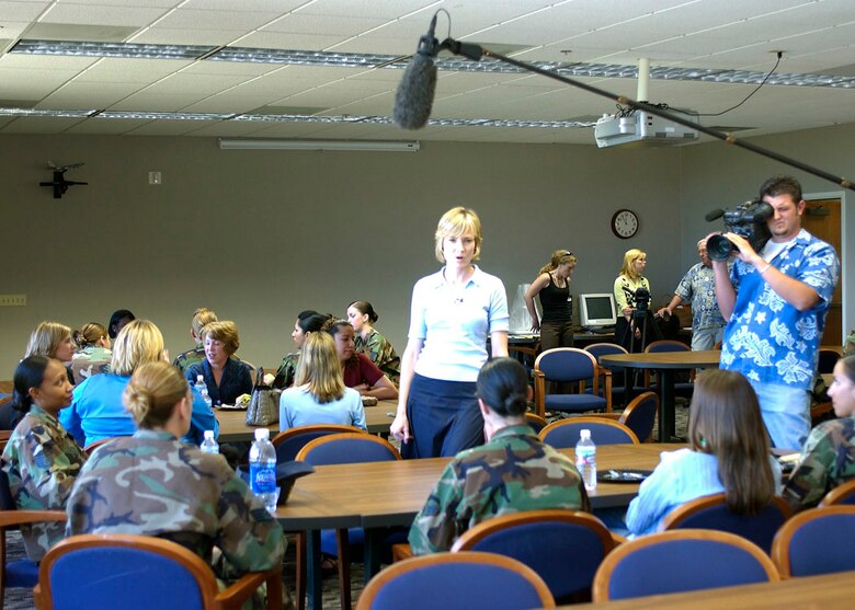 Willow Bay (left), journalist, talks with military women and military wives here as part of a documentary for the Lifetime television network Monday.  (Photo by Senior Airman Francesca Carrano)