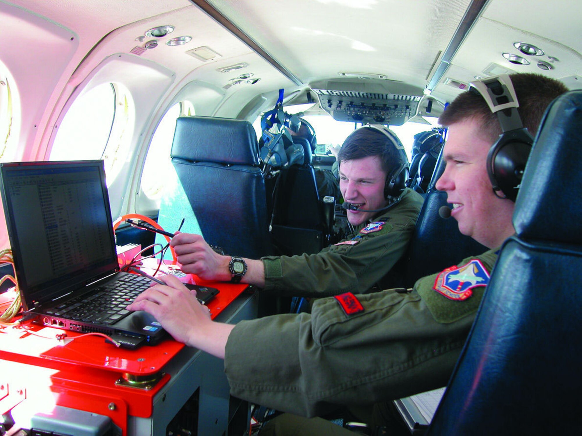 Capt. Michael Dooley (front) and Capt. Troy Welker, U.S. Air Force Test Pilot School students, work on their final Test Management Project, "HAVE HALO."  TPS Class 05B graduated June 10, 2006.  (Courtesy photo)
