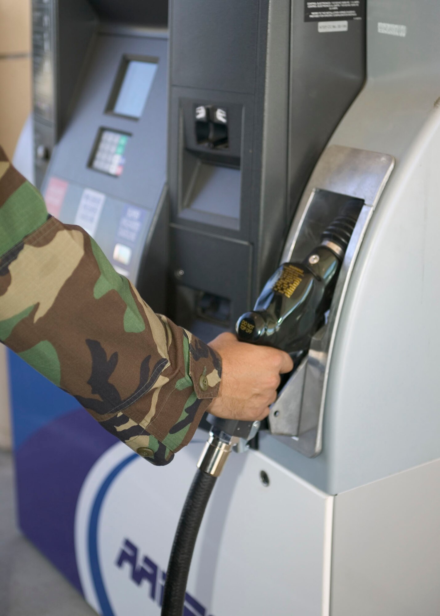 An Edwards Airman refills his vehicle tank with gas from the AAFES Car Care Center here. (Photo by Bobbi Zapka)