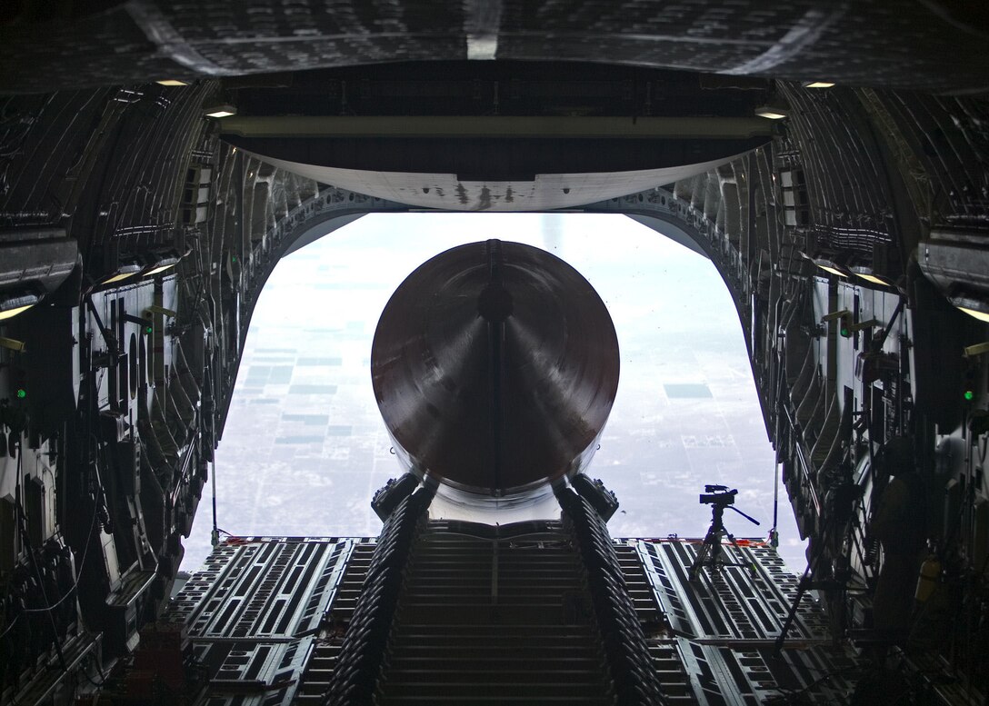 A 65-foot, 72,000-pound booster rocket mock-up exits the cargo bay of a C-17 Globemaster III July 26, 2006. The airdrop was the final test in phase 2B of the Falcon small launch vehicle program, a joint effort between Defense Advanced Research Projects Agency and the Air Force to develop a more flexible and low-cost method of putting a 1,000-pound satellite into low earth orbit. This was the longest and heaviest single item ever dropped from a C-17. (Photo by Steve Zapka)