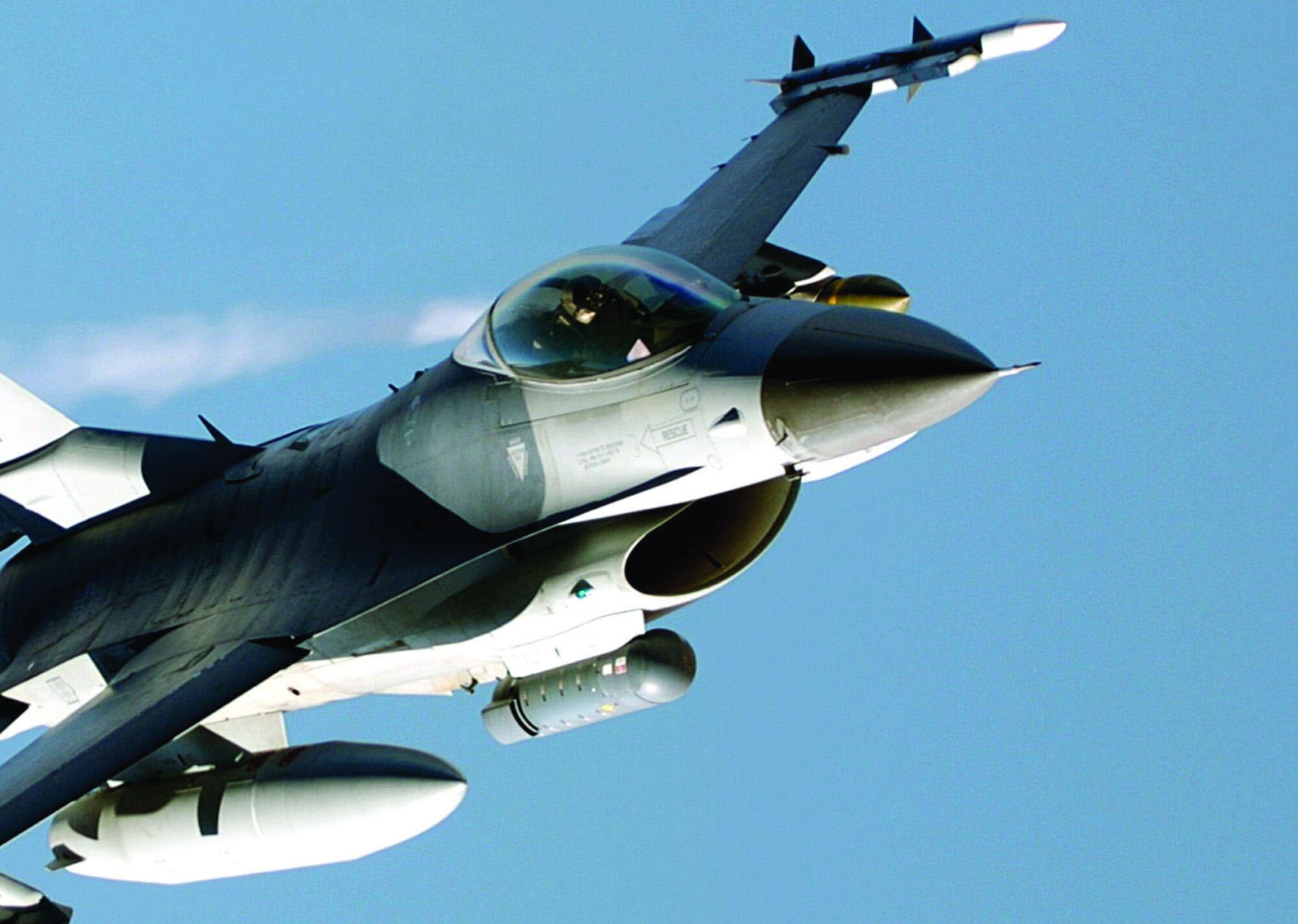 A LITENING pod, like the dark grey cylinder attached to the bottom of this F-16's fuselage, is an operational precision targeting pod system used with a wide variety of combat air forces aircraft. Edwards began accelerated testing of a LITENING-AT targeting pod here March 17, 2006. The LITENING-AT test will update the existing LITENING pod with several new capabilities, including a video downlink transmitter currently used in the Predator Unmanned Aerial Vehicle.  (Courtesy photo)