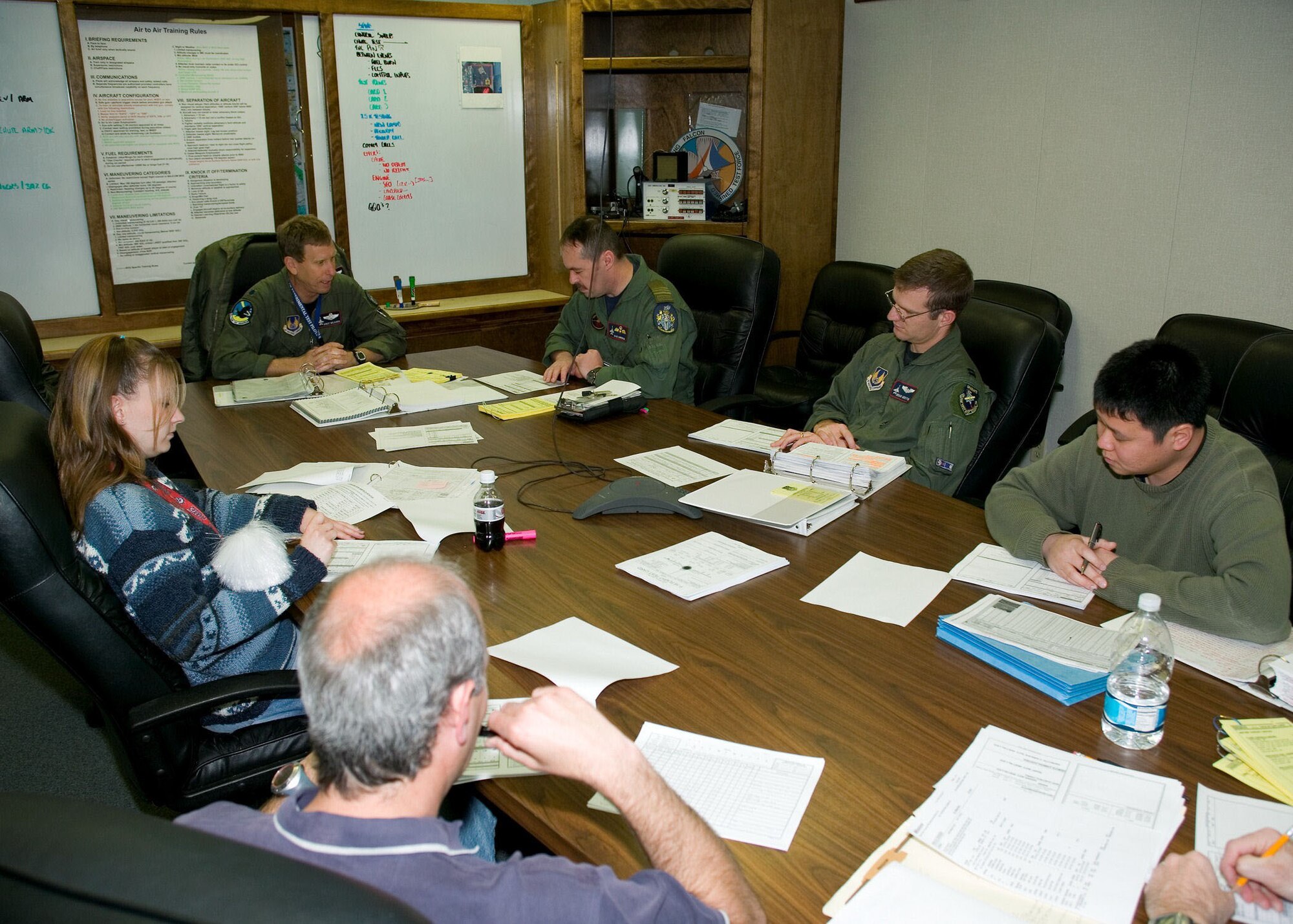 The Taiwan High Angle of Attack F-16 test team conducts a pre-flight briefing during the exercise. The overall test objective of the program was to evaluate the Block 30 F-16's high angle-of-attack handling, resistance to uncontrollable flight, and recovery characteristics while flying with a pylon designed to carry towed decoys.  (Photo by Andy Wolfe)