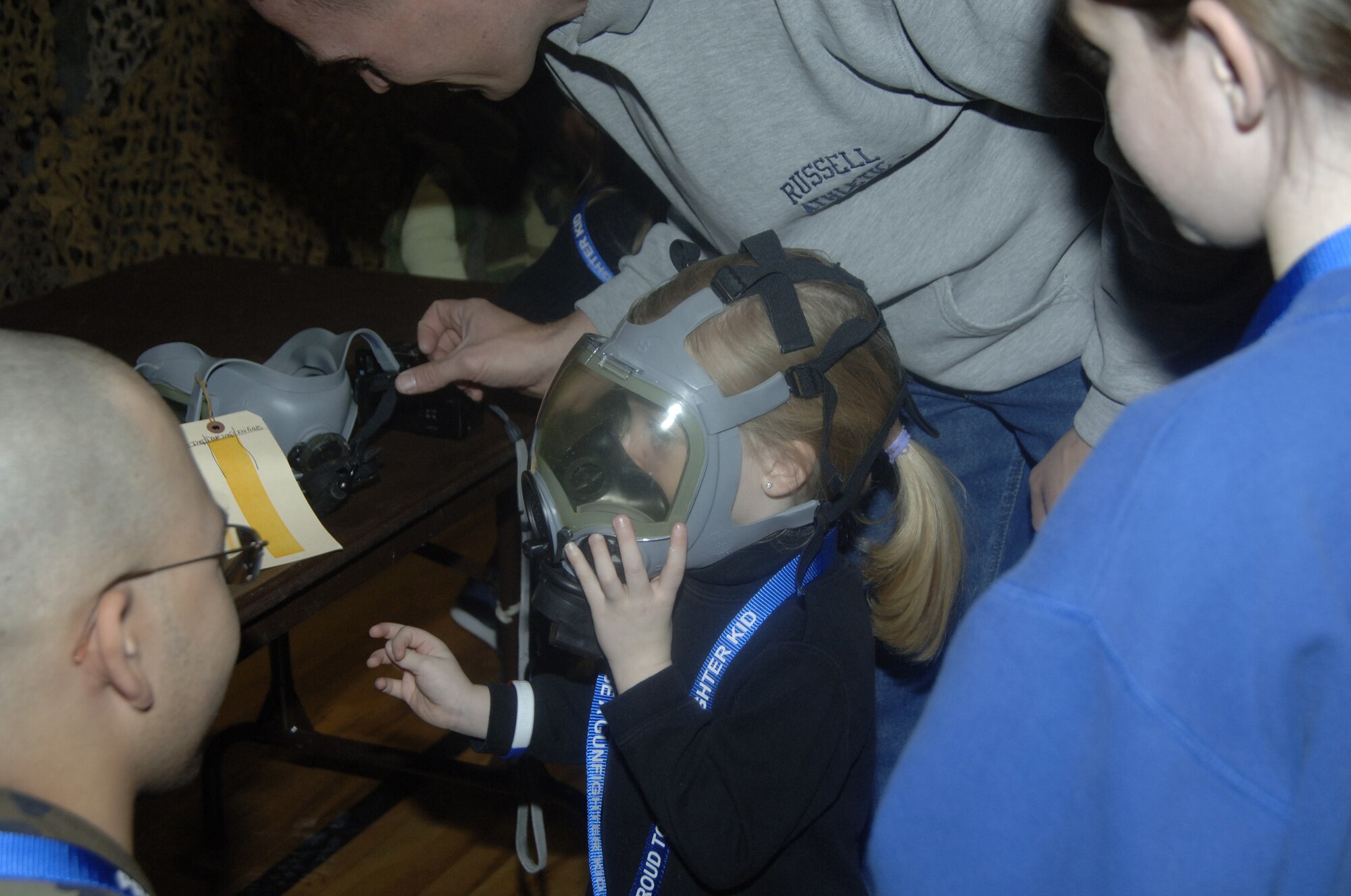 Keelie Martin, daughter of Tech. Sgt. Julie Martin, adjusts her gas mask to make sure it fits snug. Many hands-on experiences at PDF Jr. helped children understand what their parents do during deployments. (U.S. Air Force photo by Airman 1st Class Dana Hill)

