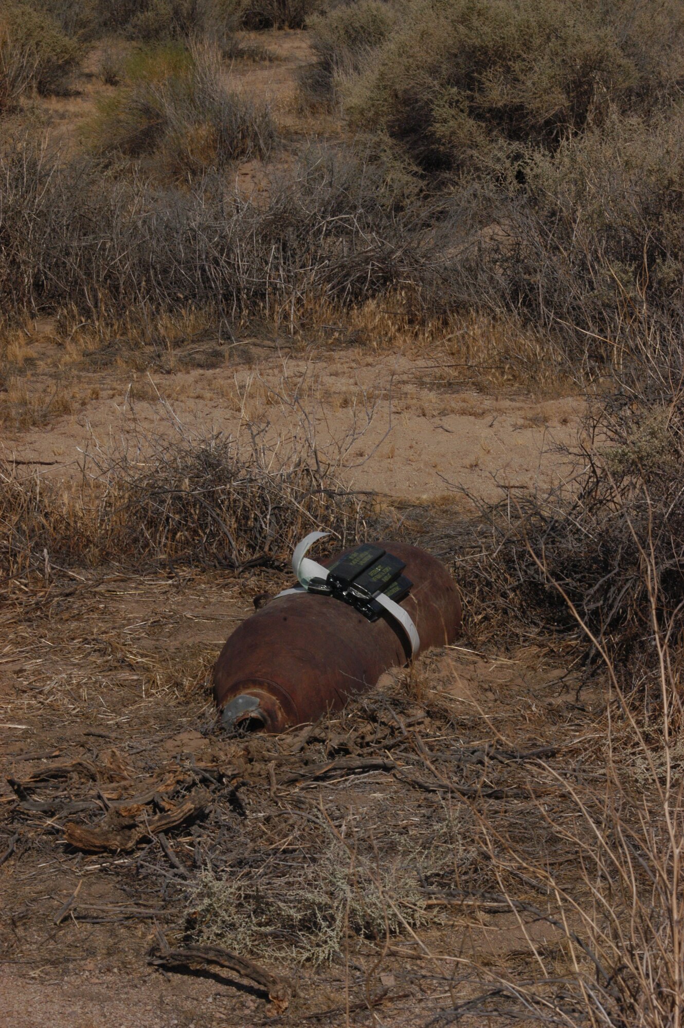 Edwards' Explosive Ordnance Disposal unit strapped charges to the top of an unexploded device found in Lancaster, Calif.   (Photo by Capt. Vince King)