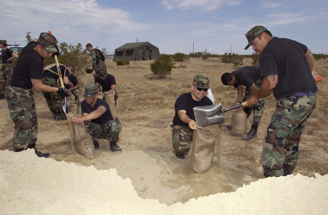 Edwards' Airmen exercise in more than one way by filling sandbags at Camp Corum on May 17, 2006. Sandbags are used to fortify defensive fighting positions. The Airmen were part of a team sent to the camp to prepare it for "deployed operations" during Phase II of an operational readiness exercise, which officially kicked off at 6 p.m. the same day. (Photo by Edward Cannon)