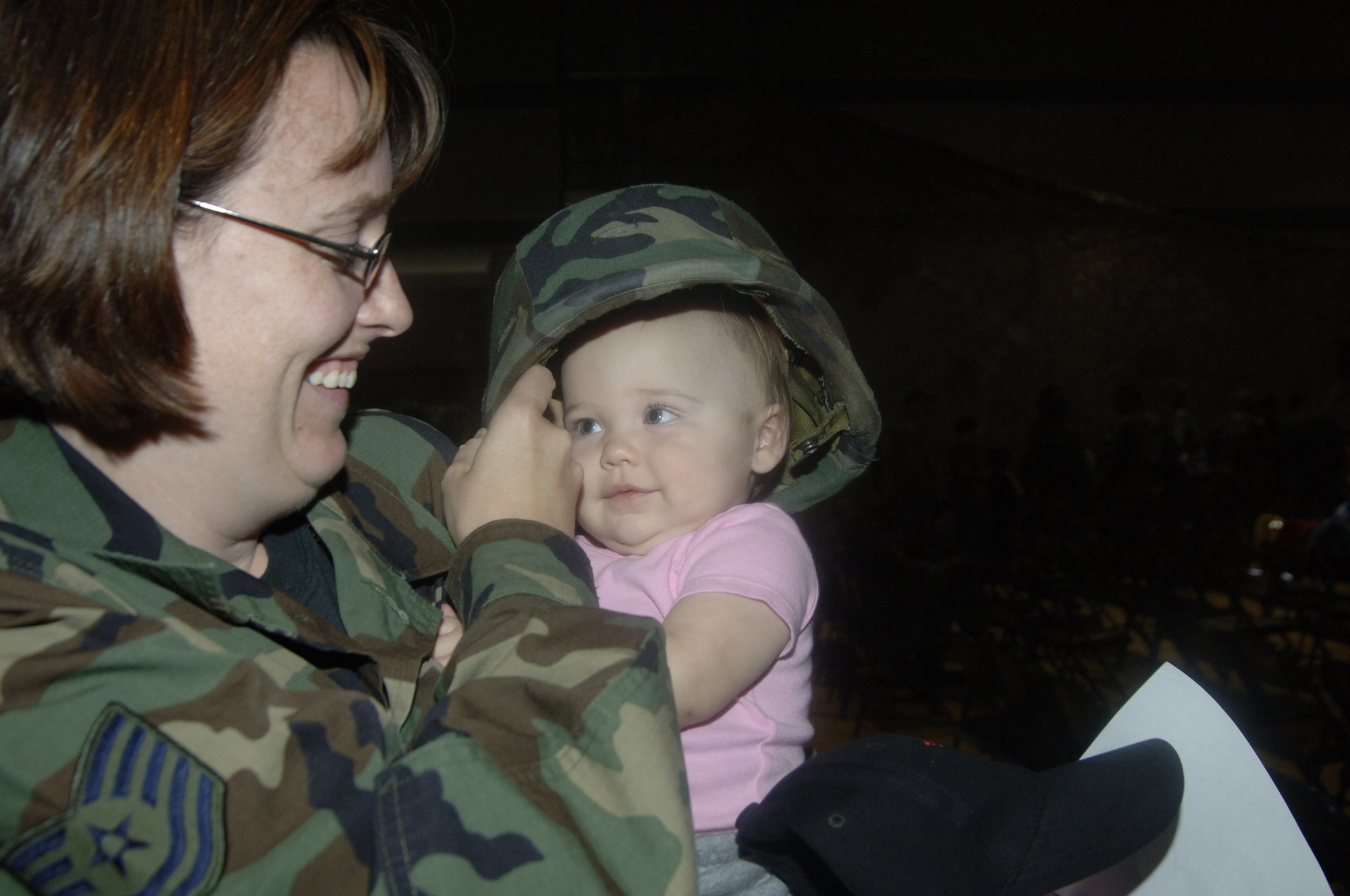 Tech. Sgt. Julie Martin, 366th CS, helps her daughter, Kalia, put on a helmet during Thursday’s events. More than 75 children of all ages attended the program sponsored by the airman and family readiness center.

