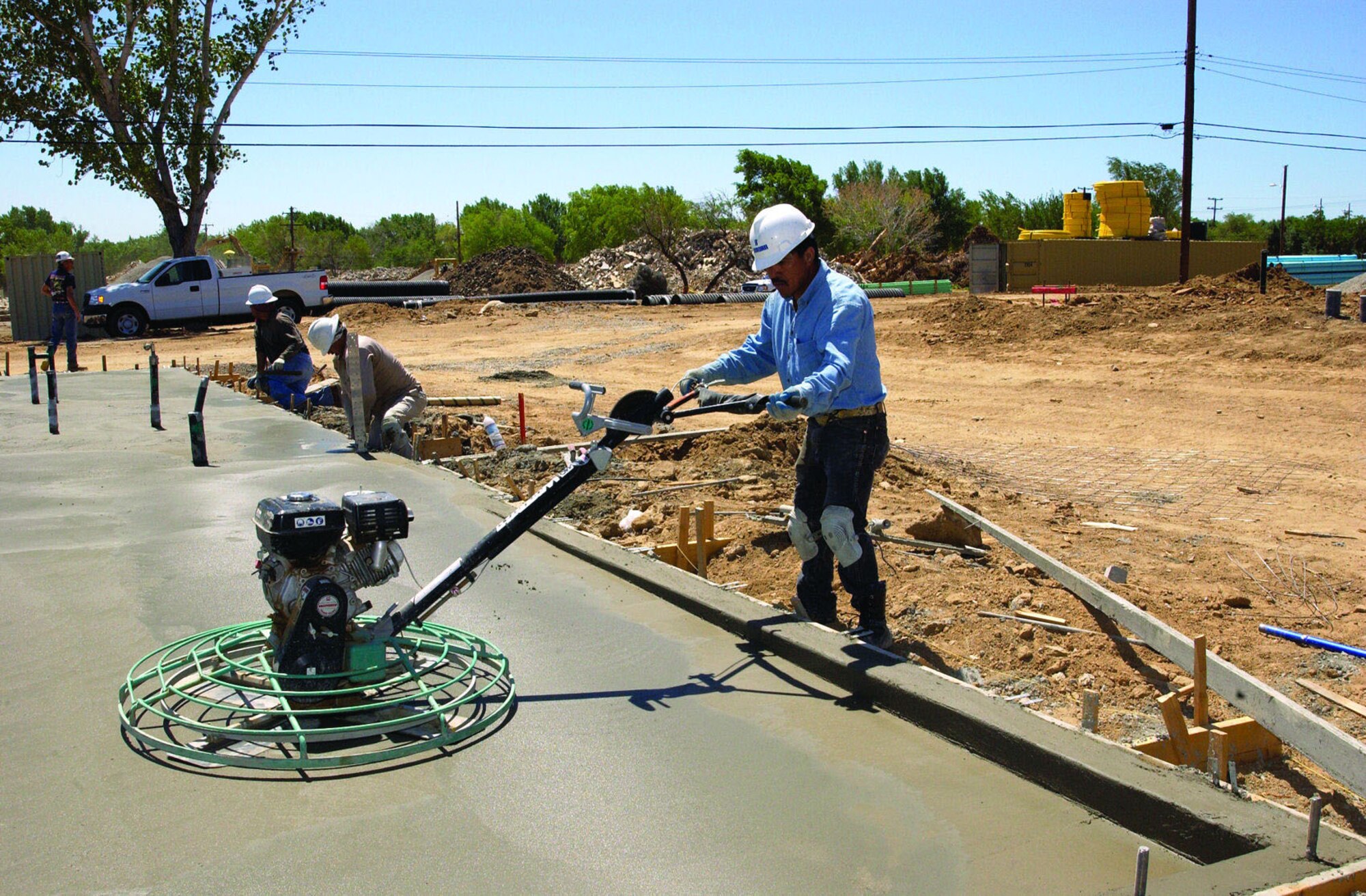Construction crews put the finishing touches on a new foundation in the Mesquite Meadows housing area June 13, 2006. The 55 new homes in the area are planned for junior enlisted occupancy and should be complete by February 2007.  (Photo by Edward Cannon)