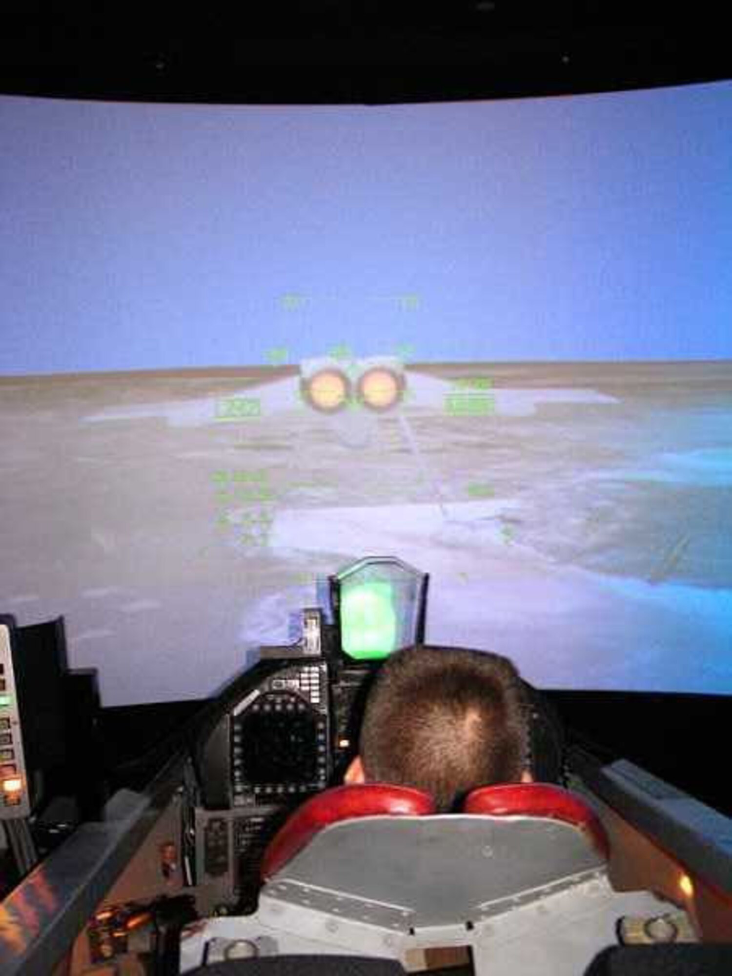 CAP Airman Basic A.J. Lafferty experiences what it's like to fly an F-18 as he pilots NASA's flight simulator during his visit here. (Photo by Civil Air Patrol Maj. Jason Markiewitz)