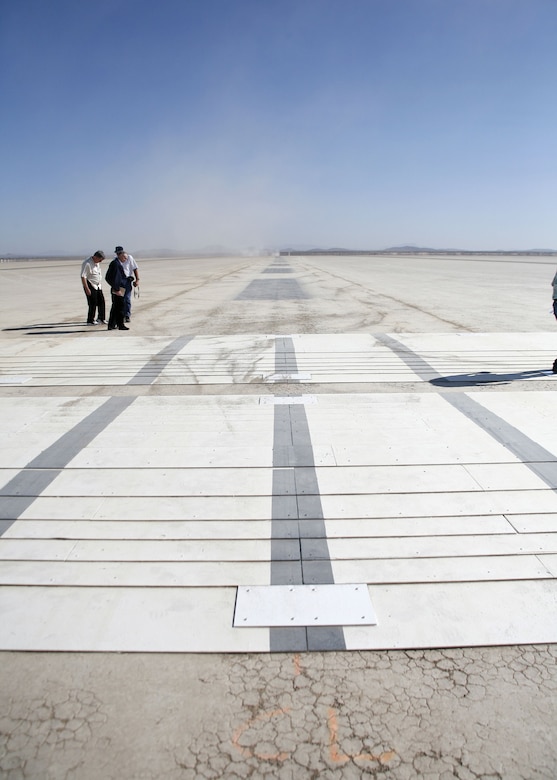 Airfield Management personnel checked for proper placement of custom designed ramps for the C-5 landing gear tests. The C-5 Galaxy completed a series of high and low-speed taxi tests on the ramps here Aug. 9, 2006.  (Photo by Jet Fabara)