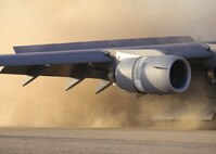 Dust envelopes the rear of a C-17 Globemaster III upon landing at Fort Hunter Liggett, Calif., recently. The C-17 was performing take-off and landing testing on semi-prepared runways as part of a test to expand the C-17 capabilities to land on dry and wet-dirt runways. (Photo by Bobbi Zapka)
