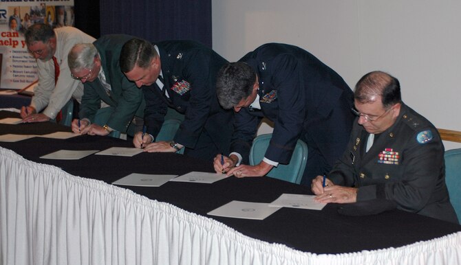 DOVER AIR FORCE BASE, Del. -- From right to left: Army Maj. Gen. Frank Vavala, Adjutant General of Delaware, Col. Sam Cox, 436th Airlift Wing commander, Col. Ronald A. Rutland, 512th Airlift Wing commander, Robert Mooney, mayor of Camden, and John Friedman, owner of Pathways Programs, signed a Statement of Support pledging their support of their employees who are members of the National Guard and Reserve. The signing occurred at the Military Affaire Nov. 14 at the Landings Club, Dover Air Force Base, Del., in front of more than 175 base and community leaders. Delaware's Employer Support of the Guard and Reserve committee sponsored the Statement of Support signing, which is designed to recognize employers for their policies and practices that are supportive of their employees' participation in the National Guard and Reserve. ESGR was established in 1972 to promote cooperation and understanding between Reserve component members and their civilian employers and to assist in the resolution of conflicts arising from an employee's military commitment. To learn more about ESGR, visit http://www.esgr.org/aboutESGR.asp. (U.S. Air Force photo/1st Lt. Marnee A.C. Losurdo)