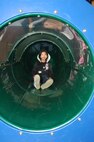 MINOT AIR FORCE BASE, N.D. -- Joenisha Flores-Johnson, 8, daughter of Lori Ann Flores-Johnson and Senior Master Sgt. Kevin Johnson, 5th Civil Engineer Squadron, enjoys her time going down a slide outside of the David C. Jones Youth Center during Fit Club Monday. (U.S. Air Force photo by Airman 1st Class Joe Rivera)