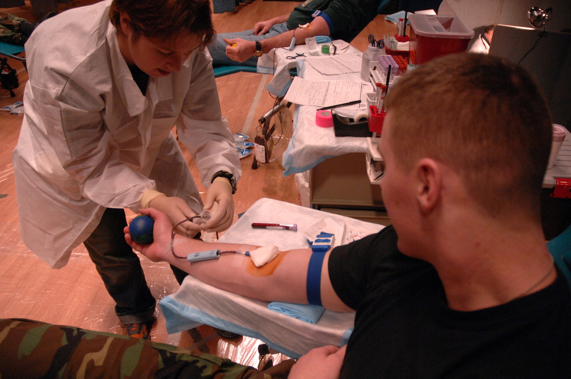 EIELSON AIR FORCE BASE, Alaska -- Susan Baker, manager, Blood Bank of Alaska Fairbanks Center, collects blood from Airman Kyle Kremer, 354th Medical Group, during the Blood Bank's mobile blood drive here on 21 Nov. The Blood Bank of Alaska supplies blood to military and civilian hospitals throughout Alaska.
(U.S. Air Force Photo by Staff Sgt Joshua Strang)