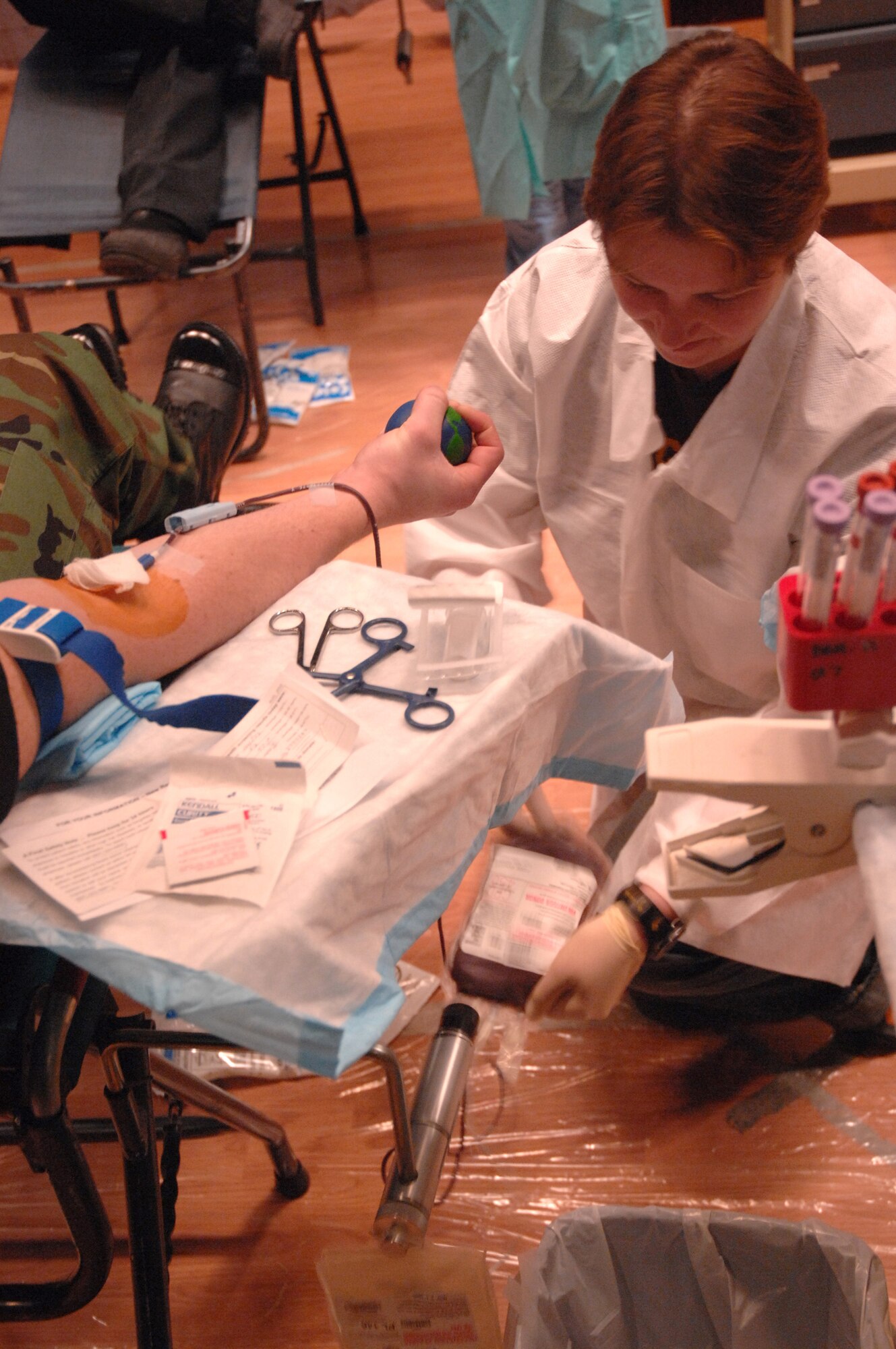 EIELSON AIR FORCE BASE, Alaska -- Susan Baker, manager, Blood Bank of Alaska Fairbanks Center, checks the blood collection of Airman Kyle Kremer, 354th Medical Group, during the Blood Bank's mobile blood drive here on 21 Nov. The Blood Bank of Alaska supplies blood to military and civilian hospitals throughout Alaska.
(U.S. Air Force Photo by Staff Sgt Joshua Strang)