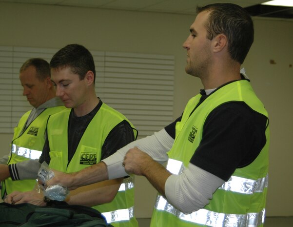 Tech. Sgt. Edward Mackiel and Senior Airman Joshua Jankowski, 819th RED HORSE Squadron, prepare their CERT bags to enter the simulated disaster area.