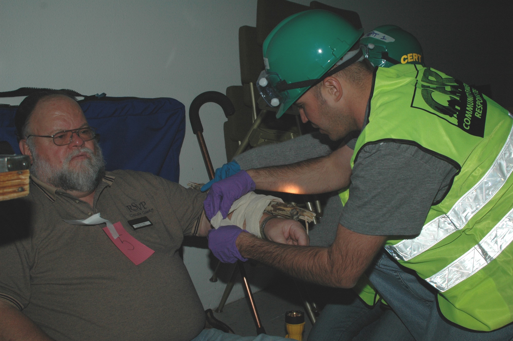 Senior Airman Nick Bluter, 741st Missile Security Forces Squadron, treats a patient's wounds at the simulated disaster site. 