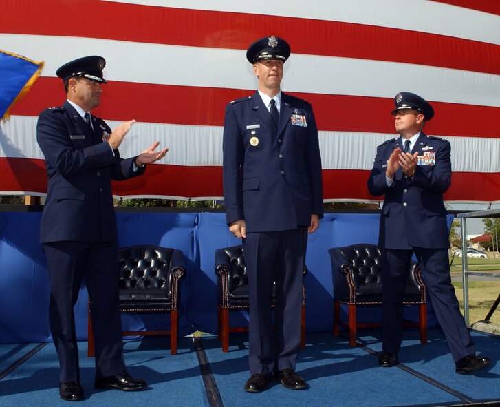 (Photo by Terry Wasson ) Col. Richard Klumpp Jr. (center) receives congratulations from Maj. Gen. Marc Rogers, 19th Air Force commander, and outgoing 71st Flying Training Wing Commander Col. Bryan Benson after assuming command of the wing Sept. 15.  