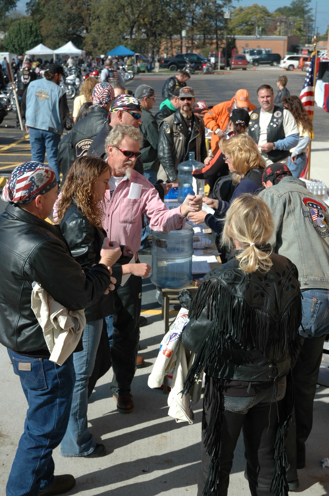 Walter Bailey, technical sergeant and member of the 917th Maintenance Squadron, and daughter, Cherie, and others pass through event  registration during the Veterans for Veterans Bike Event Nov. 11, 2006, held at Overton Brooks Veterans Administration Hospital in Shreveport Louisiana (U.S. Air Force photo/Master Sgt. Gerry Currington)