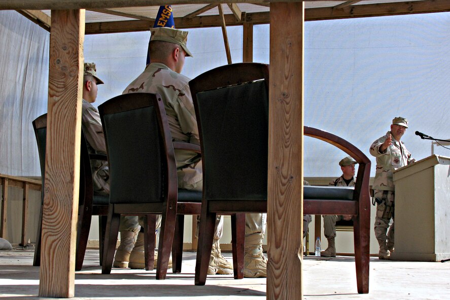 CAMP BUCCA, Iraq - Col. Paul Curlett, 386th Air Expeditionary Wing commander, addresses Staff Sgt. Rory Sturm (center foreground) and Airman Kevin Perez Glazer (left foreground) who were presented Purple Hearts at a ceremony here Nov. 14 for wounds received when their patrol Humvee was struck by an improvised explosive device Oct. 16. Both Airmen are deployed to the 586th Expeditionary Security Forces Squadron Area Security Operations. (U.S. Air Force photo/Capt. Jeff Clark)