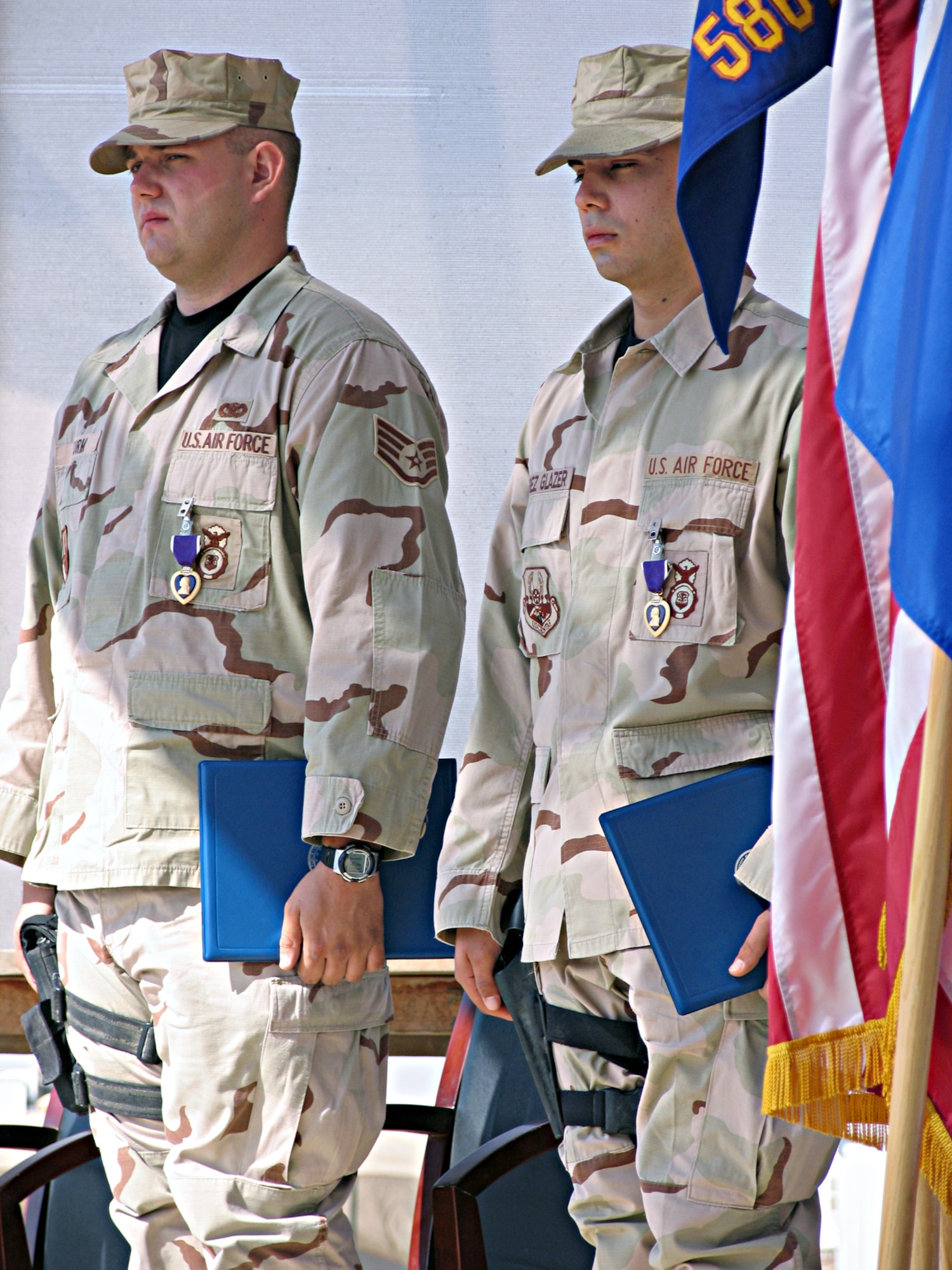 CAMP BUCCA, Iraq - Staff Sgt. Rory Sturm and Airman Kevin Perez Glazer were presented Purple Hearts at a ceremony here Nov. 14 for wounds received when their patrol Humvee was struck by an improvised explosive device Oct. 16. Both Airmen are deployed to the 586th Expeditionary Security Forces Squadron Area Security Operations. (U.S. Air Force photo/Capt. Jeff Clark)