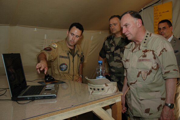 Capt. Claudio Scheffler, French Air Force, briefs Gen. Tom Hobbins, U.S. Air Forces in Europe commander, on the Mirage unit deployed to Dushanbe, Tajikistan May 19. General Hobbins stopped through Dushanbe to visit with the deployed French unit that supports air operations for International Security Assistance Forces. Over the past year, General Hobbins has visited more than 30 nations in 2006. (U.S. Air Force photo/Capt. Krista Carlos)