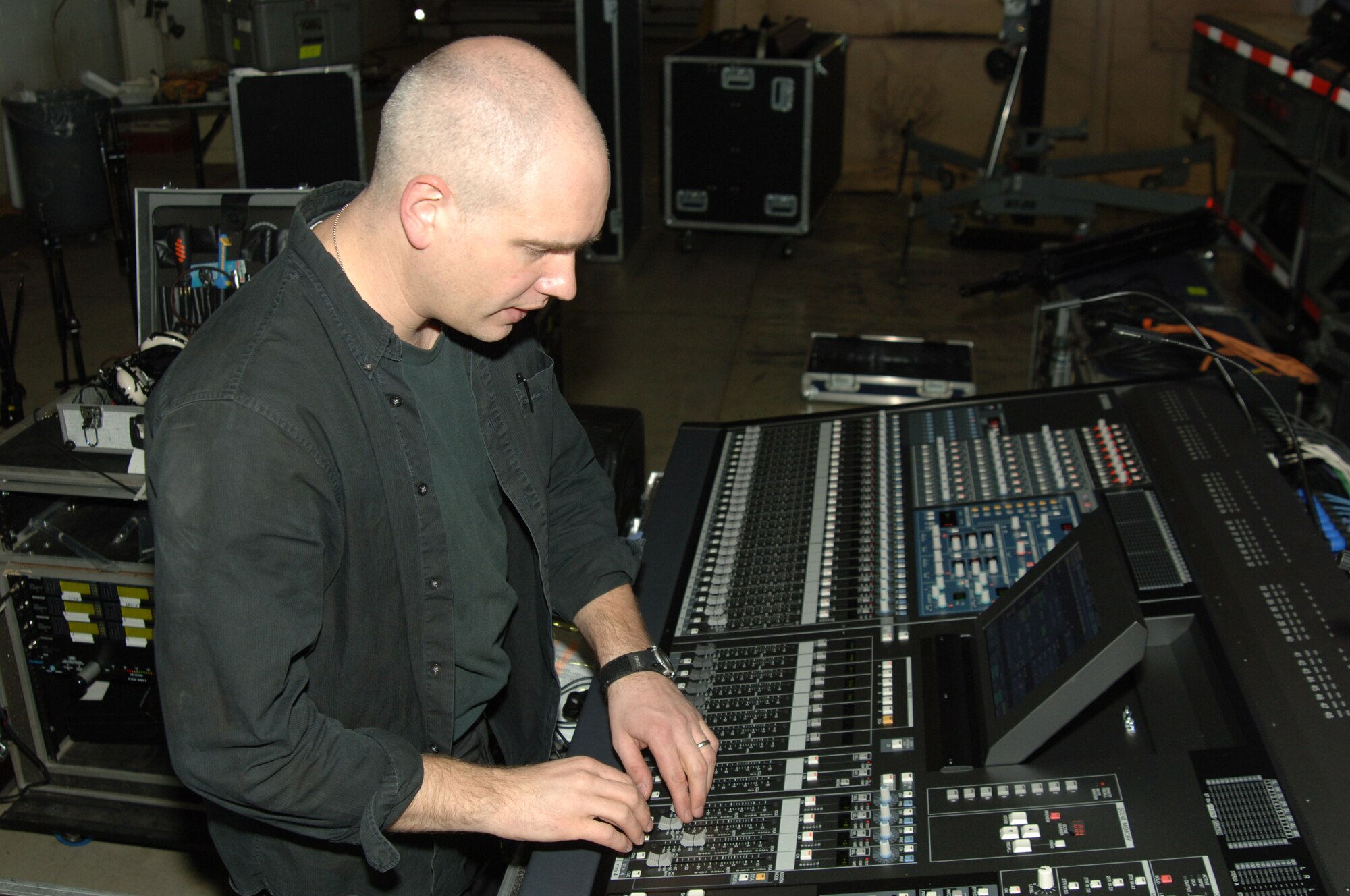 Staff Sgt. Michael Smith, U.S. Air Forces in Europe band member from Sembach Air Force Base, Germany, helps to set up the audio for the Operation Season's Greetings concert Nov. 21. The OSG concert is scheduled for 2 p.m. inside Hangar 4, admission is free. (U.S. Air Force photo by Airman Kelly L. LeGuillon)