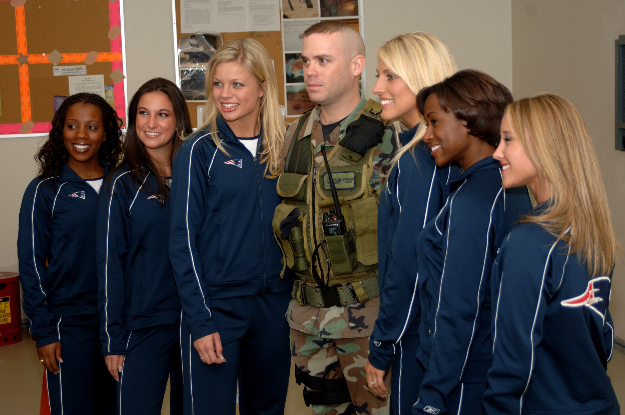 Master Sgt. Daniel Morgan, 39th Security Forces Squadron, poses with the members of the New England Patriot's cheerleading squad at the 39th SFS armory Nov. 21. The Patriot Cheerleaders spent the day visiting the Airmen of Incirlik as part of Operation Season's Greetings. (U. S. Air Force photo by Airman First Class Nathan W. Lipscomb)