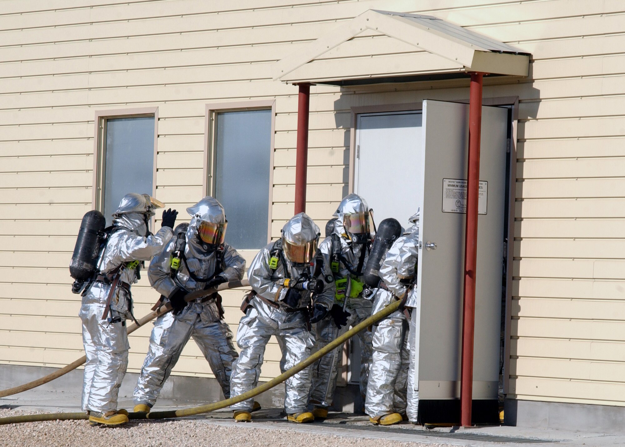 Incirlik Air Base firefighters from Engine 12 and Engine 13 begin to enter the fire training facility while responding to a call during an exercise, 20 November. The fire training facility is designed for Incirlik firefighters to conduct exercises and can reach temperatures as high as 1,200 degrees Fahrenheit. (U.S. Air Force photo by Airman Kelly LeGuillon)          