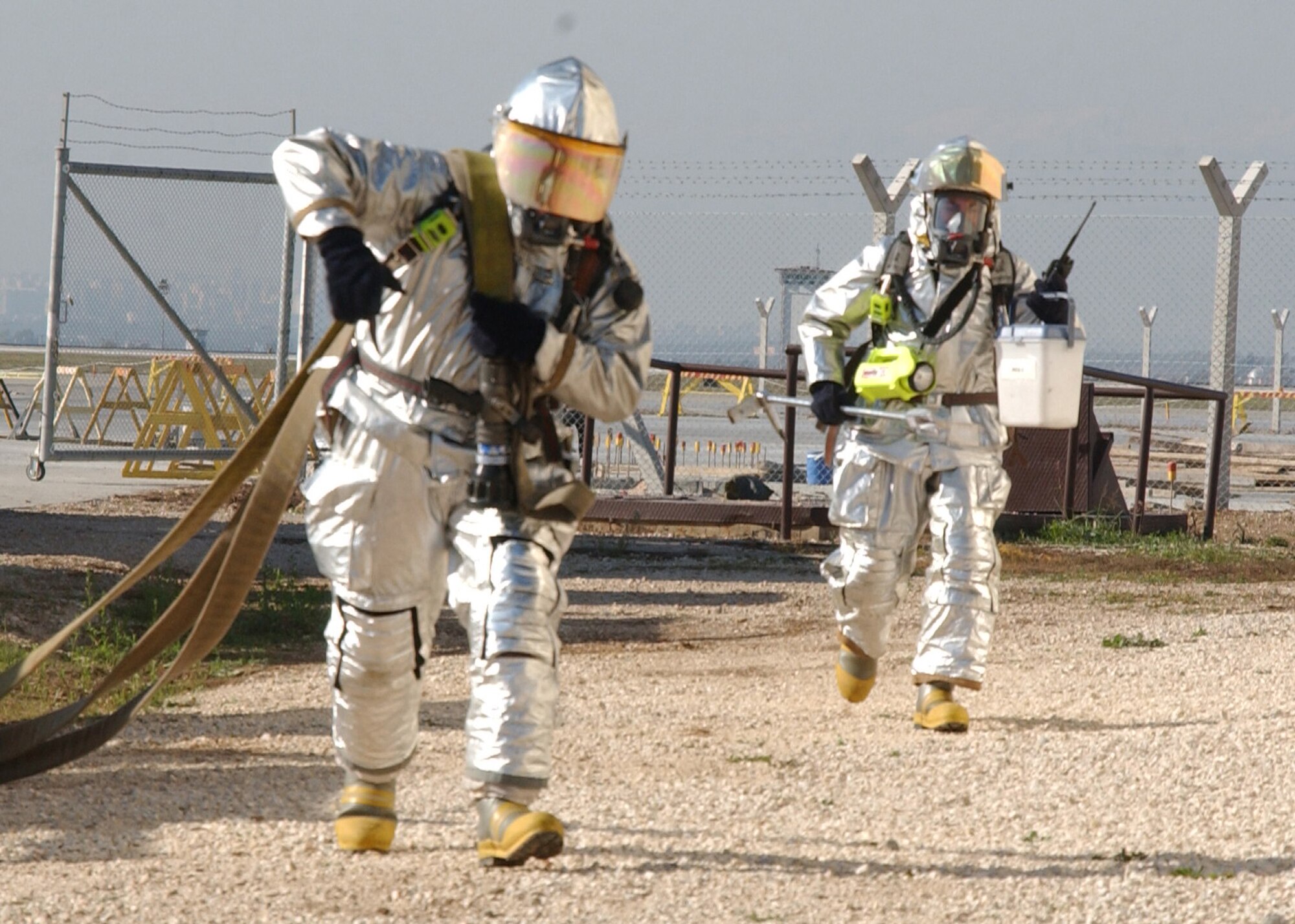 Incirlik Air Base firefighters from Engine 12, second run pumper, run the hose to the fire training facility during an exercise Nov. 20. The Incirlik firefighters conduct structural fire exercises quarterly. (U.S. Air Force photo by Airman Kelly LeGuillon)                                         