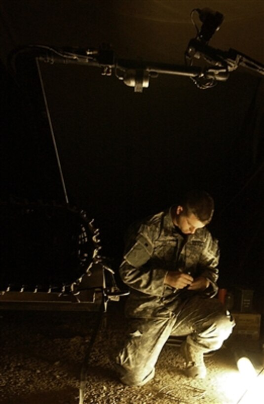 U.S. Air Force Senior Airman Carl Dill makes last minute adjustments to his equipment before an operation at forward operating base Bernstein on Nov. 14, 2006.  Dill is assigned to an explosive ordnance disposal team.  
