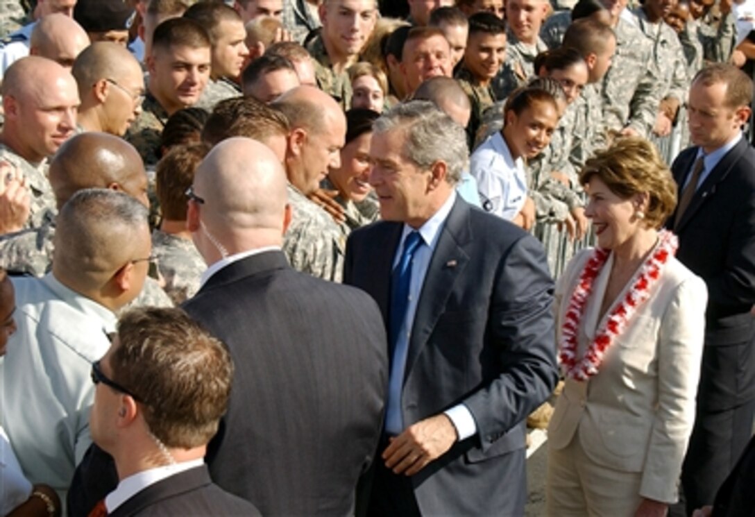 President George W. Bush and First Lady Laura Bush meet with servicemembers on the flightline at Hickam Air Force Base, Hawaii, Nov. 21, 2006, before boarding Air Force One for their return to Washington, D.C. 