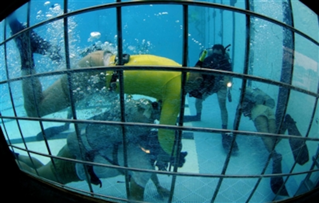 A Naval Diving and Salvage Training Center instructor provides a problem-solving scenario to a dive student during an exercise at the pool confidence-training portion of the student's course, in Panama City, Fla., Nov. 18, 2006. Students are trained to stay calm during loss of air situations without going to the surface. 